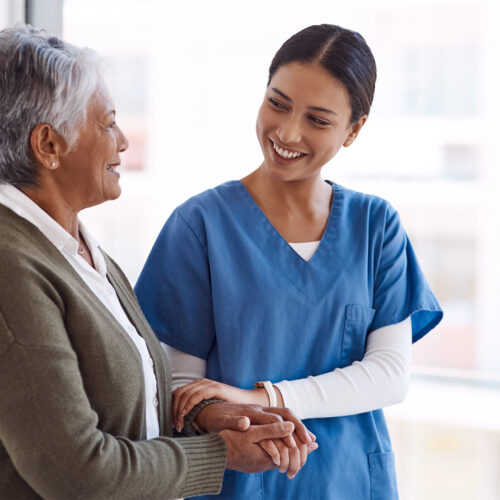 Compassionate home health care provider assisting an elderly woman, emphasizing personalized nursing and senior care services for improved quality of life.