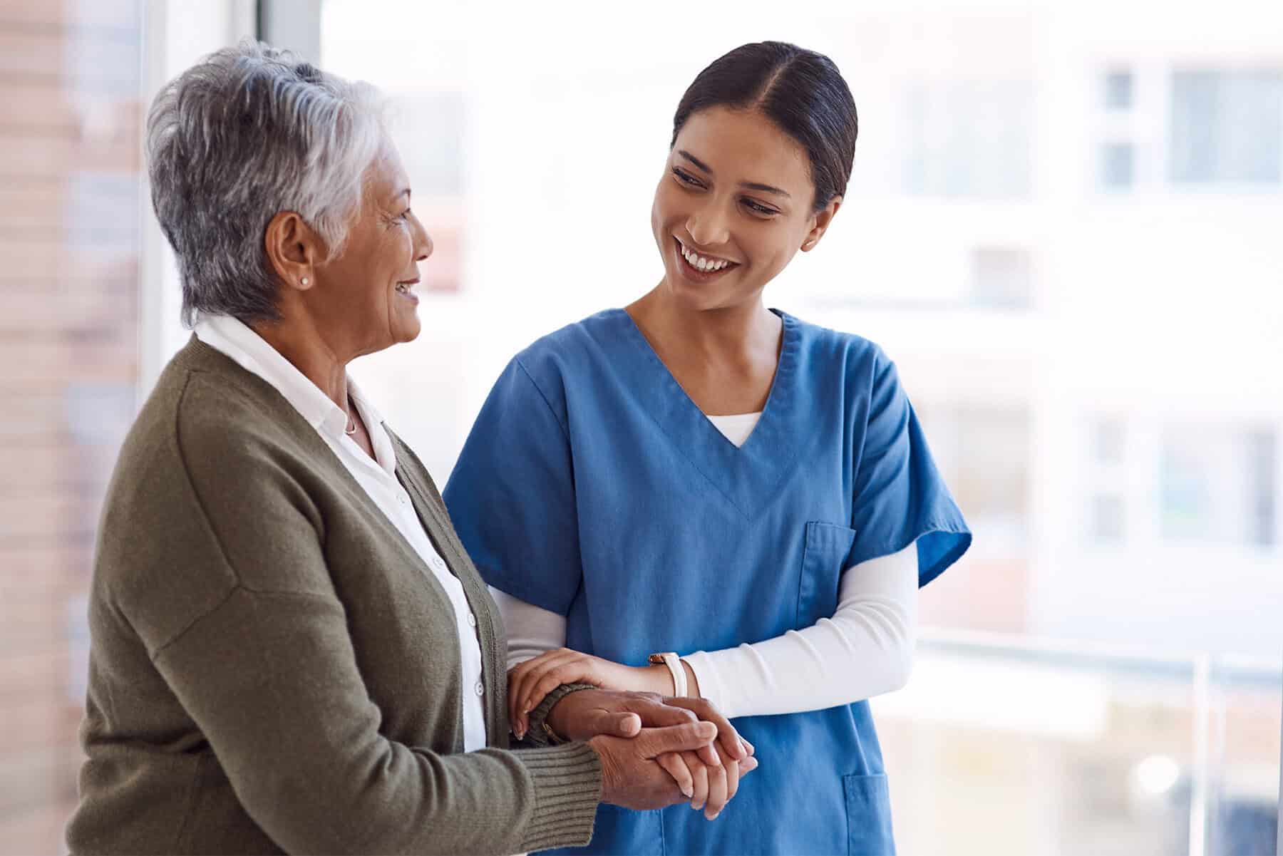 Compassionate home health care provider assisting an elderly woman, emphasizing personalized nursing and senior care services for improved quality of life.
